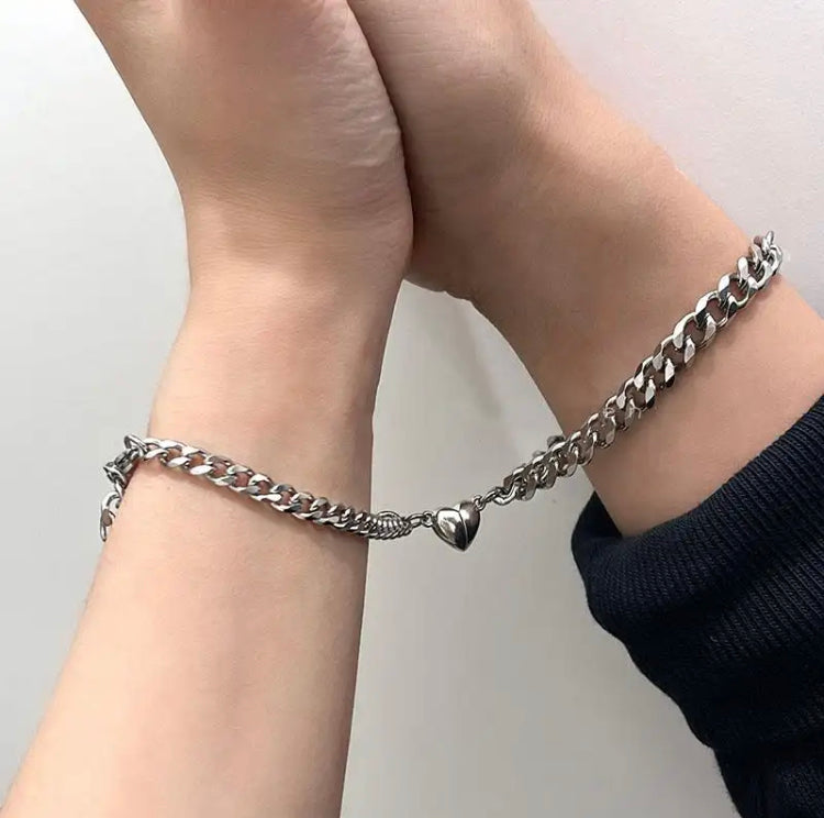 Steel Bond Heart Couple Bracelet – Magnetic steel bracelets with a bonded heart design, symbolizing love and connection in a sleek, durable style for couples. - couple wearing while holding hands