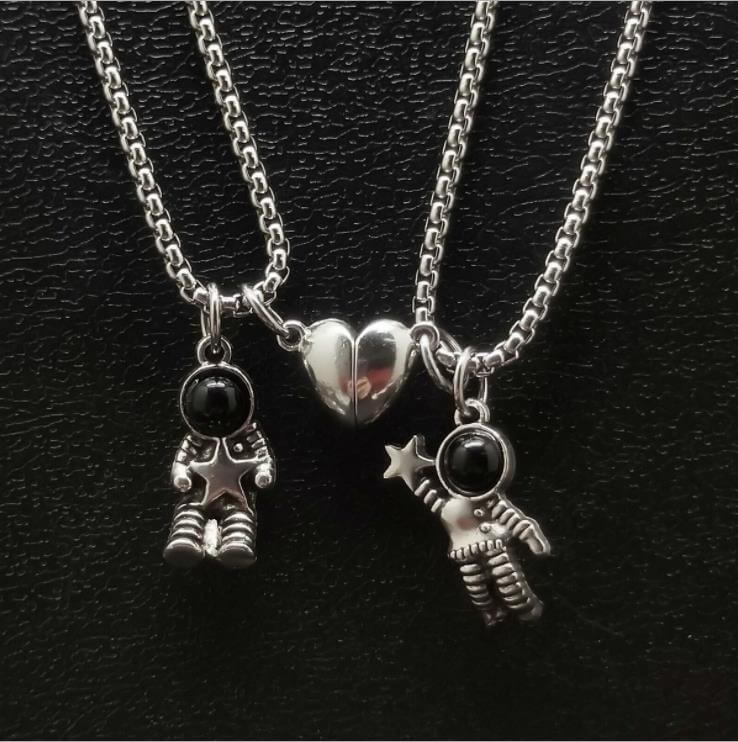 The Astronaut Couple BFF Necklace in a black background - Heart shaped