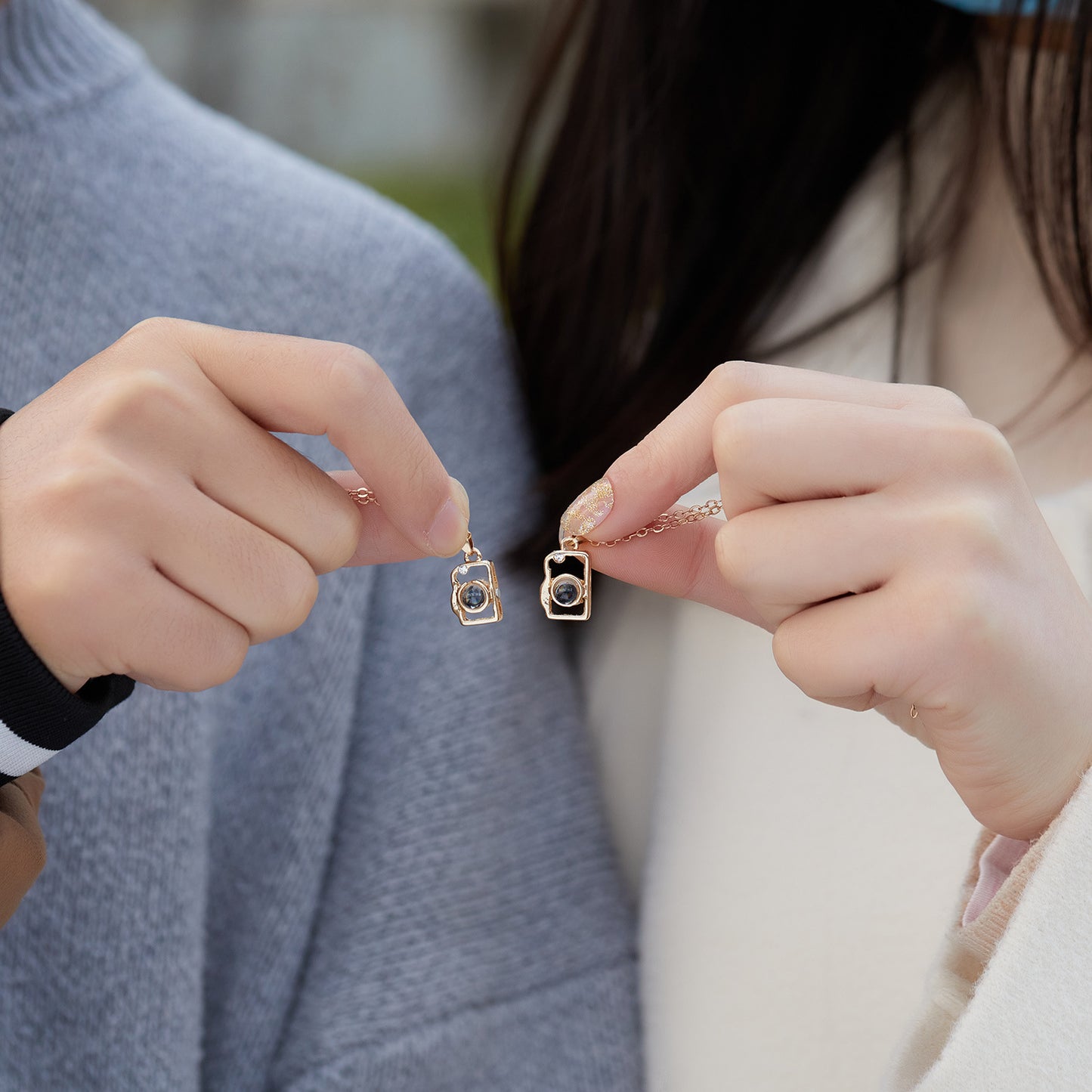 I Love You in 100 Languages BFF Camera Necklace - Couple holding the necklaces