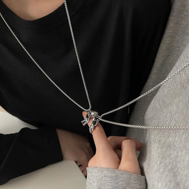 A couple wearing round shaped Astronaut Couple BFF Necklace - top view