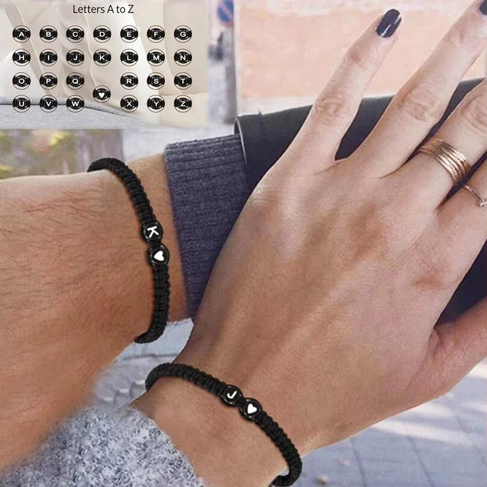 Initial Heart Couple String Bracelet: Black adjustable string bracelet featuring personalized initial and heart beads, perfect for couples or best friends. - couple wearing bracelets