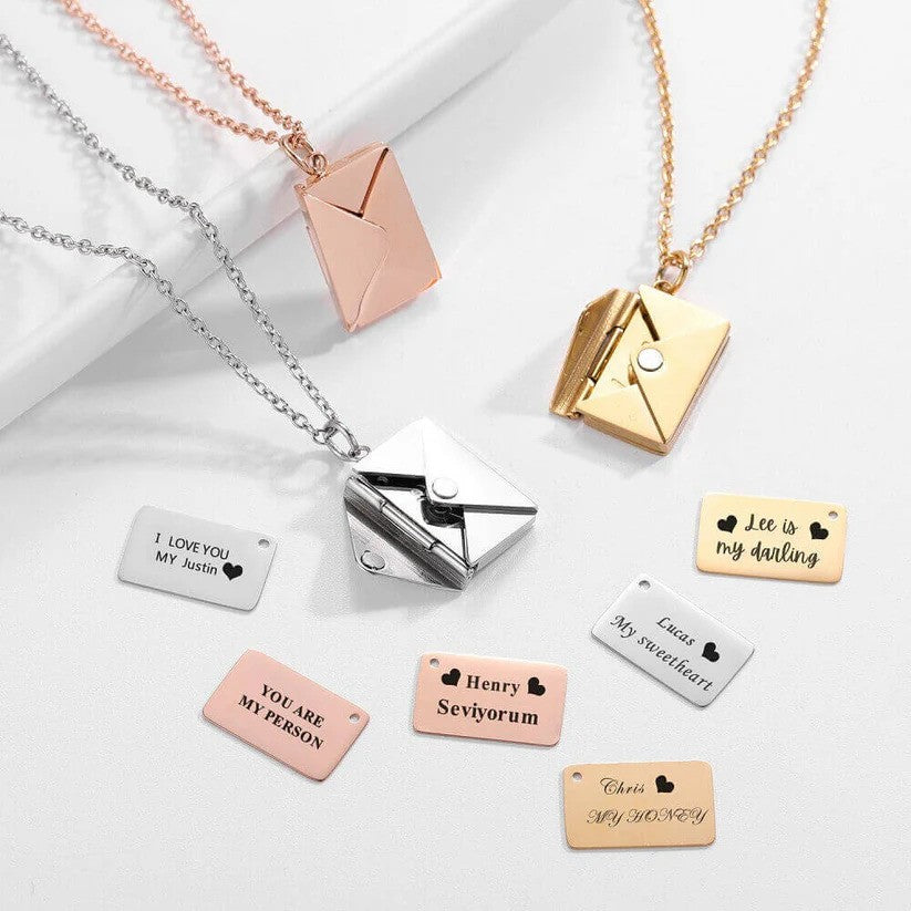 A collection of Custom Engraved Love Letter Necklaces in gold, rose gold, and silver, displayed with engraved message plates and pendants.