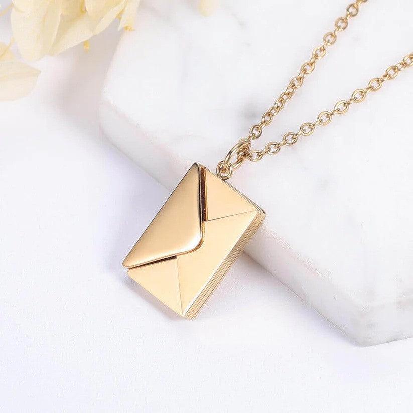 Close-up of a gold Custom Engraved Love Letter Necklace, showcasing its elegant envelope design with a smooth, polished finish on a delicate chain.